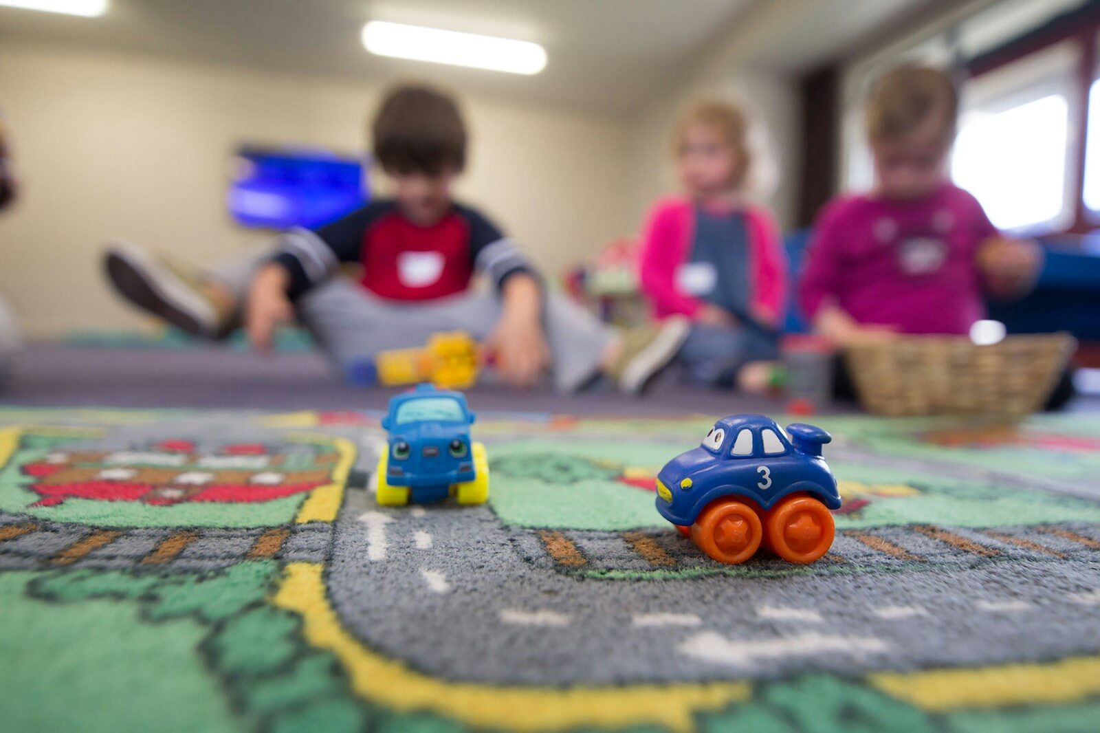 Infant/Toddler childcare at New Hope Chapel a group of children playing with toys on the floor