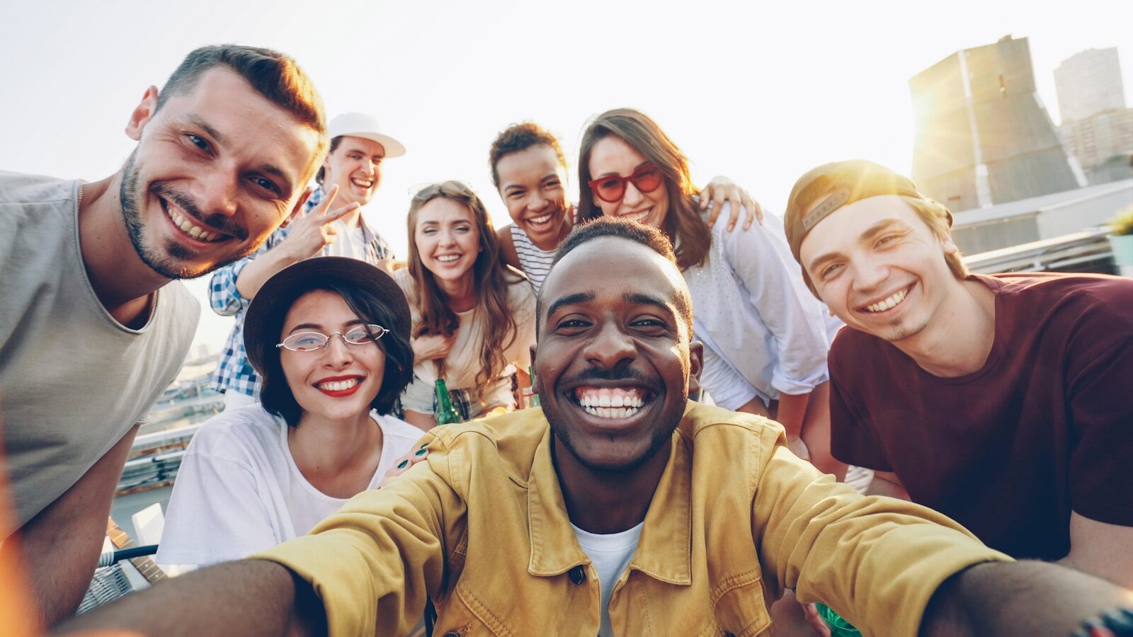 Photo by Vitaly Gariev A diverse group of friends smiling together outdoors
