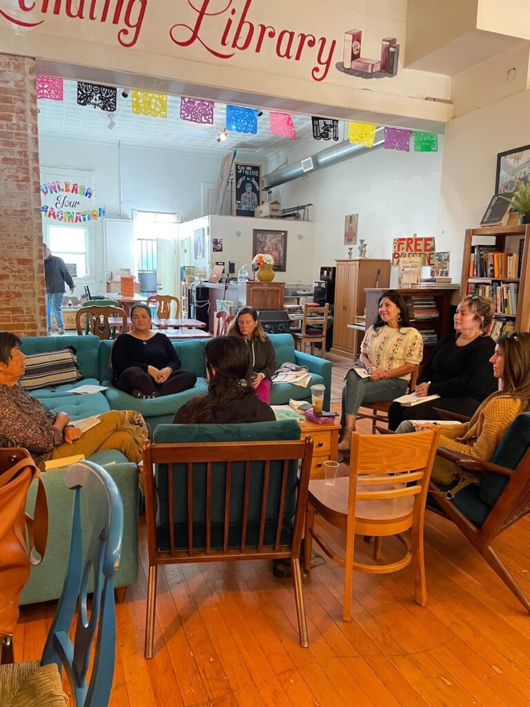 A group of people sitting around in a library